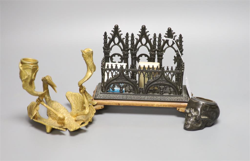 A novelty skull inkwell letter rack and a crane two branch candlestick